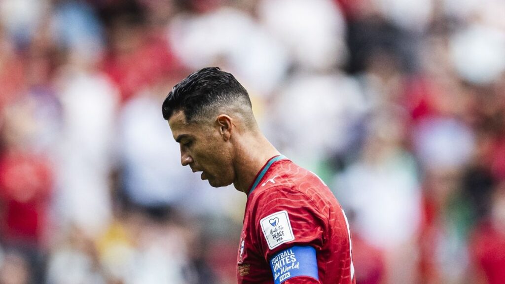 Portugal manager Roberto Martinez giving instructions to captain Cristiano Ronaldo on the pitch