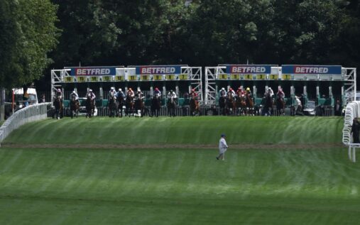 Jockey Ronan Whelan celebrating on horseback after winning the 2026 Epsom Derby