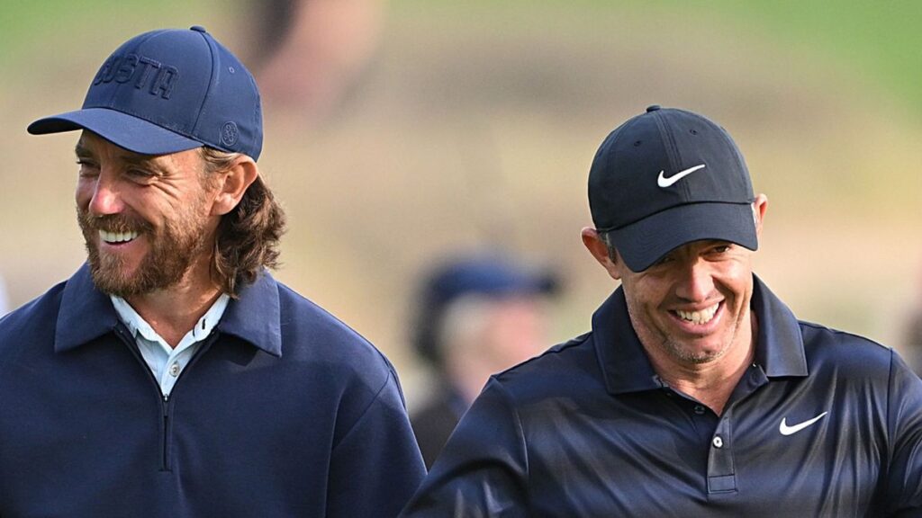 Rory McIlroy swinging a golf club on the fairway during a major tournament