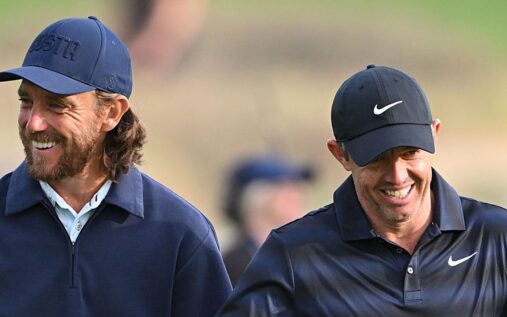 Rory McIlroy swinging a golf club on the fairway during a major tournament