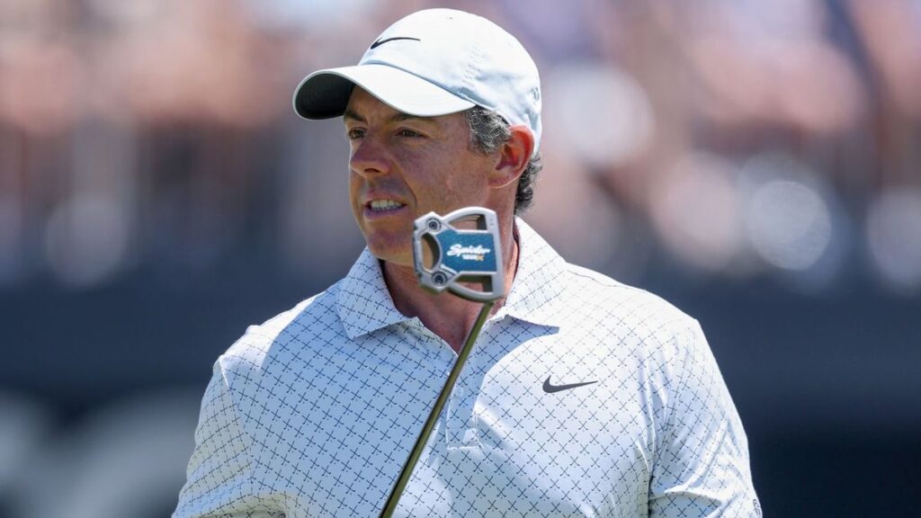 Rory McIlroy examining the course layout at Royal Birkdale ahead of the Open Championship