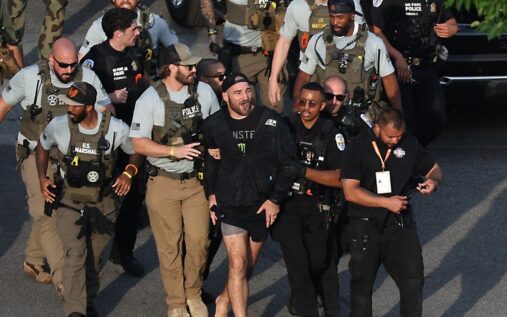 UFC middleweight champion Sean Strickland being escorted by US Secret Service personnel near the White House