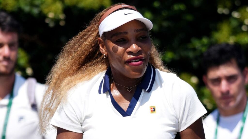 Serena Williams playing a forehand on a grass court at Wimbledon