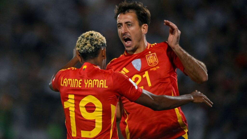 Mikel Oyarzabal and Fabian Ruiz celebrating on the pitch for the Spain national football team