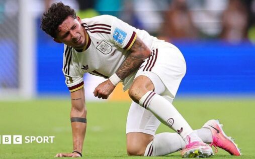 Spain winger Yeremy Pino holding his injured left shoulder in pain during the World Cup match against Uruguay