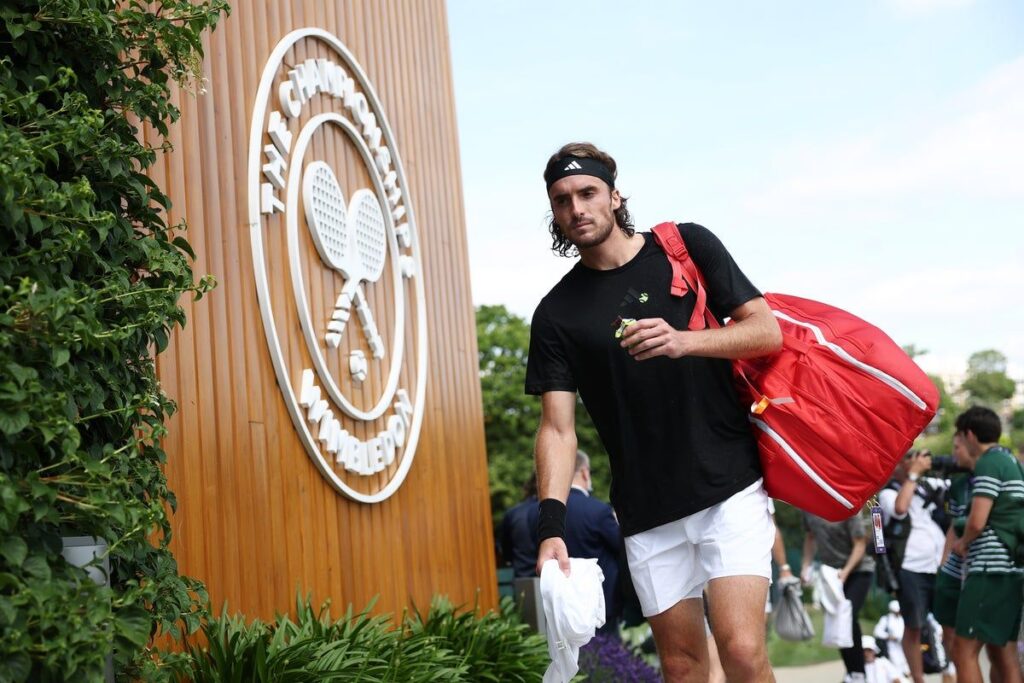 Stefanos Tsitsipas looking disappointed on a tennis court