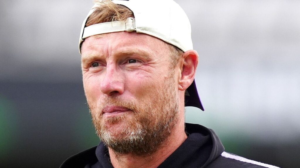 Andrew Flintoff wearing a coaching kit while standing on a cricket field
