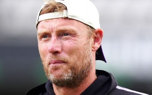 Andrew Flintoff wearing a coaching kit while standing on a cricket field