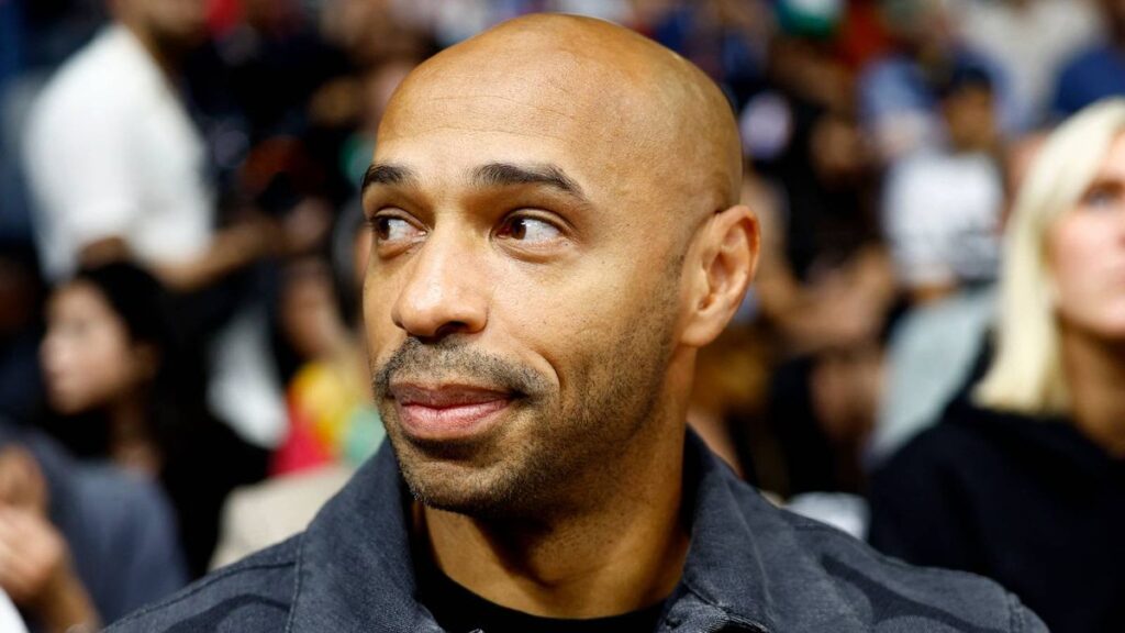 Thierry Henry looking thoughtful in a television studio while analysing international football