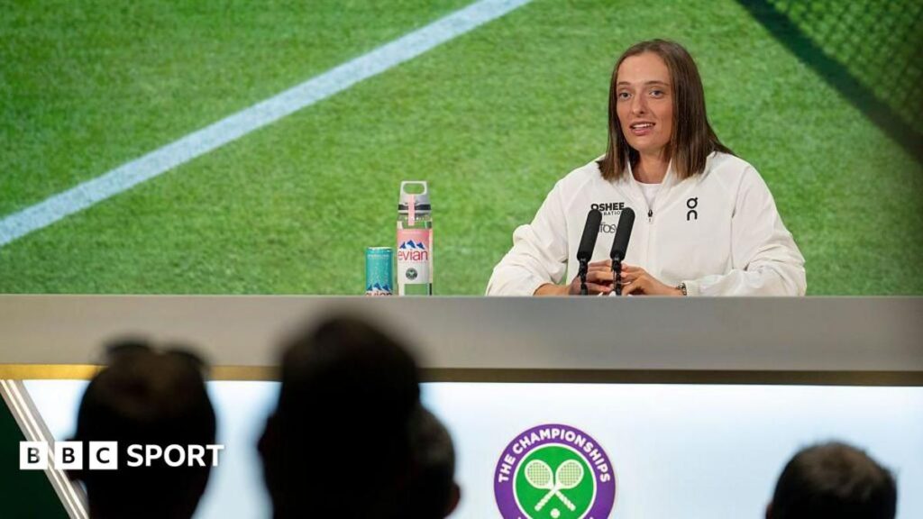 A tennis player sitting at a press conference microphone, representing the ongoing media protests at Wimbledon.