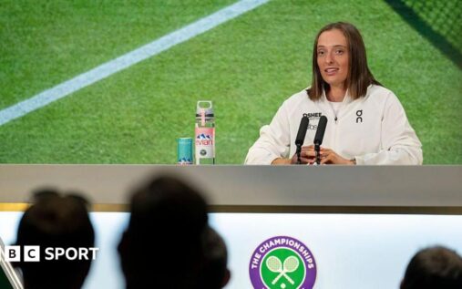 A tennis player sitting at a press conference microphone, representing the ongoing media protests at Wimbledon.
