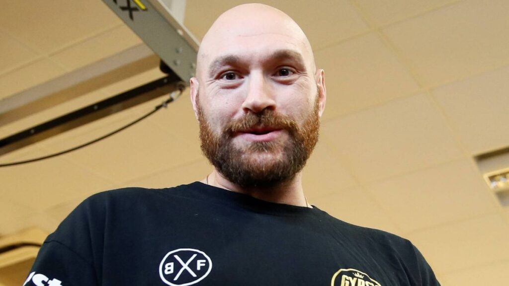 Tyson Fury pointing confidently inside a boxing ring during a match