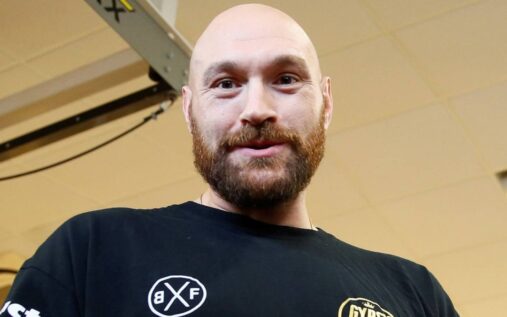 Tyson Fury pointing confidently inside a boxing ring during a match