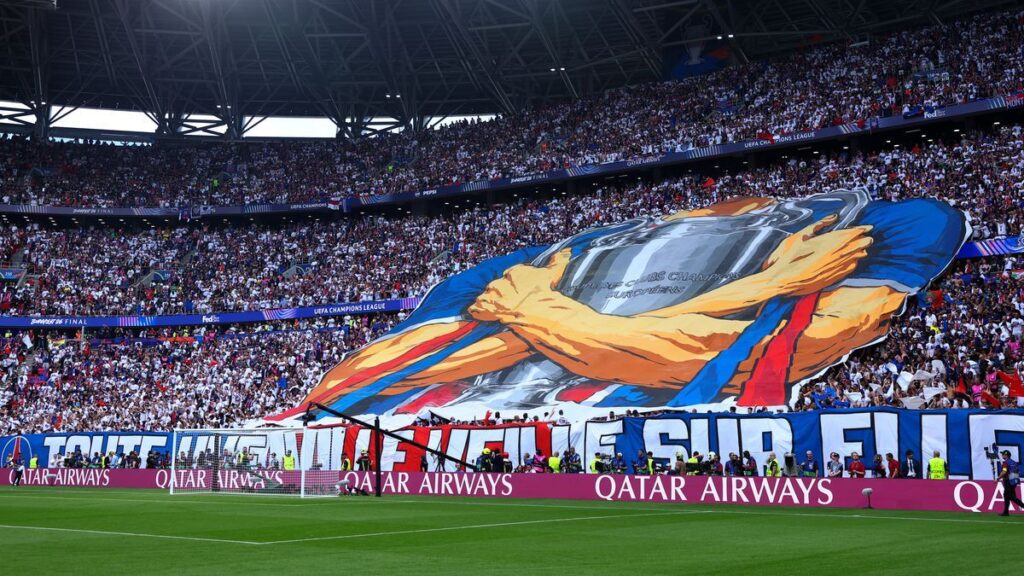 Paris Saint-Germain fans lighting red flares in the stands during the Champions League final