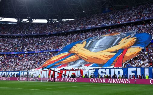 Paris Saint-Germain fans lighting red flares in the stands during the Champions League final