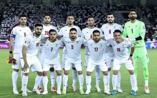 Iran national football team players lining up on the pitch before a match