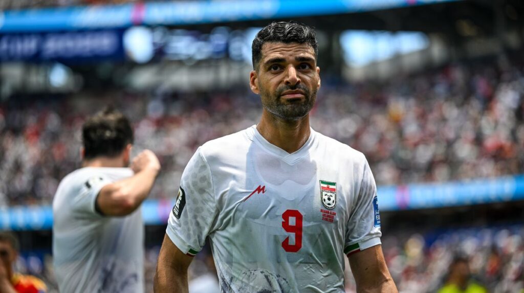 Iran striker Mehdi Taremi looking serious on the pitch during a match