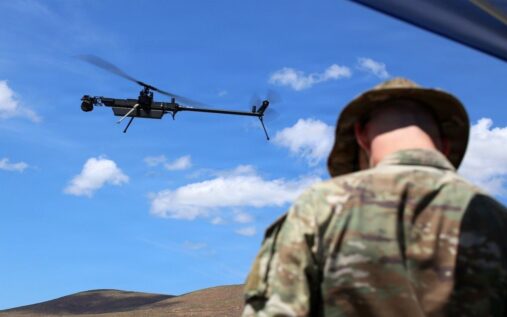 Police officers operating drone surveillance equipment outside an American stadium