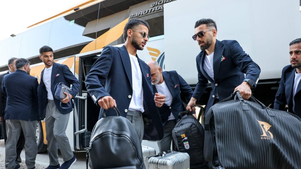 Iran national football team players line up on the pitch ahead of an international match
