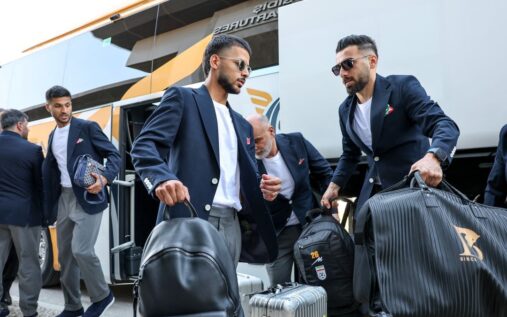 Iran national football team players line up on the pitch ahead of an international match