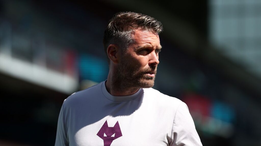Rob Edwards standing on the touchline managing a Wolverhampton Wanderers match
