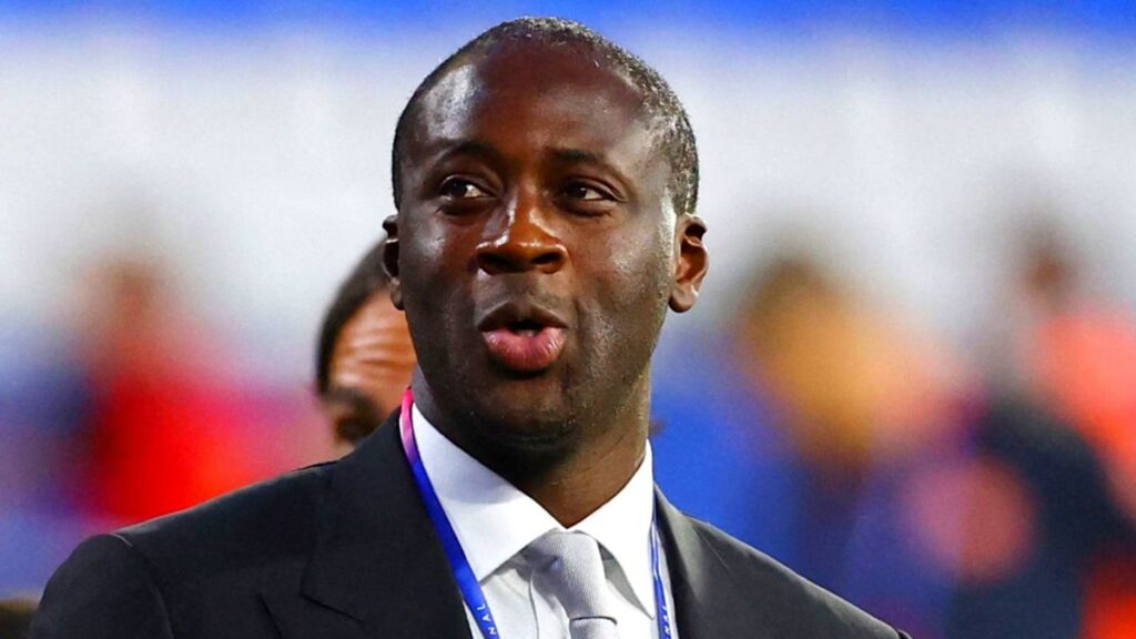 Yaya Toure standing on the touchline in coaching gear